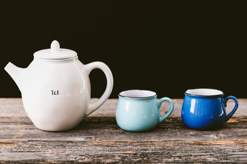 White tea pot and blue tea cups